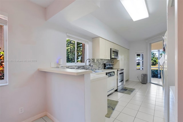 23158 Island Vw Unit 1, Boca Raton, FL 33433 - kitchen featuring appliances with stainless steel finishes, a sink, healthy amount of natural light, and tasteful backsplash