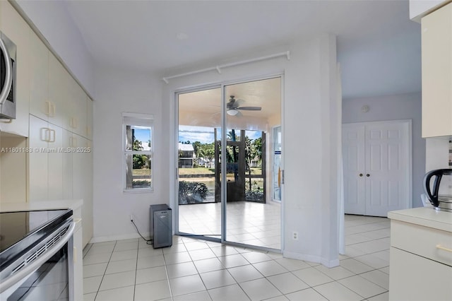 23158 Island Vw Unit 1, Boca Raton, FL 33433 - unfurnished dining area with light tile patterned floors, ceiling fan, and baseboards