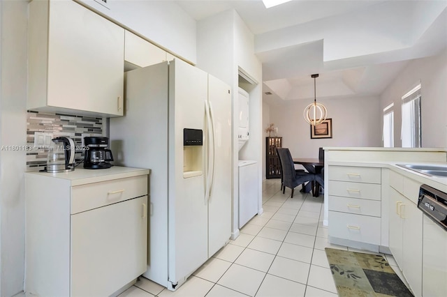 23158 Island Vw Unit 1, Boca Raton, FL 33433 - kitchen featuring stacked washing machine and dryer, dishwashing machine, tasteful backsplash, white refrigerator with ice dispenser, and light tile patterned floors