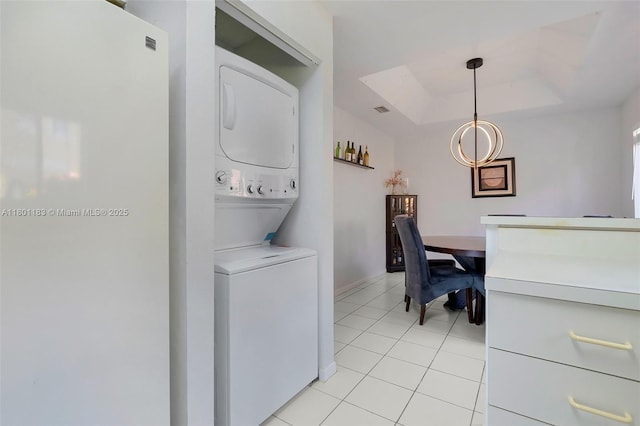 23158 Island Vw Unit 1, Boca Raton, FL 33433 - washroom featuring stacked washer / dryer, light tile patterned flooring, and a chandelier