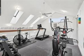 23158 Island Vw Unit 1, Boca Raton, FL 33433 - workout area with lofted ceiling, ceiling fan, a skylight, and carpet floors