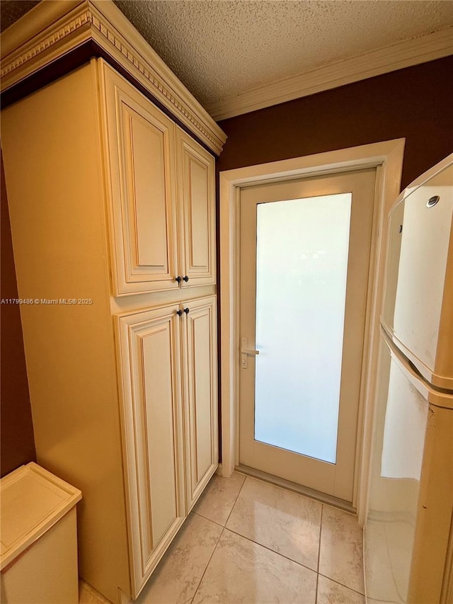 400 SE 10th St Unit 214, Deerfield Beach, FL 33441 - doorway featuring crown molding, light tile patterned flooring, and a textured ceiling