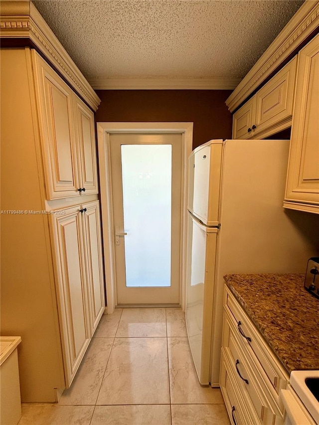 400 SE 10th St Unit 214, Deerfield Beach, FL 33441 - kitchen with electric range, cream cabinets, a textured ceiling, crown molding, and freestanding refrigerator