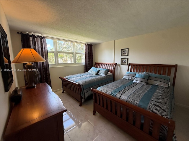 400 SE 10th St Unit 214, Deerfield Beach, FL 33441 - bedroom with a textured ceiling and baseboards