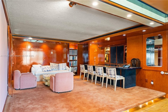 11111 Biscayne Blvd Unit 227, Miami, FL 33181 - living area with a textured ceiling, crown molding, and wood walls