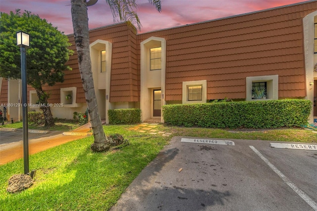 view of property featuring uncovered parking