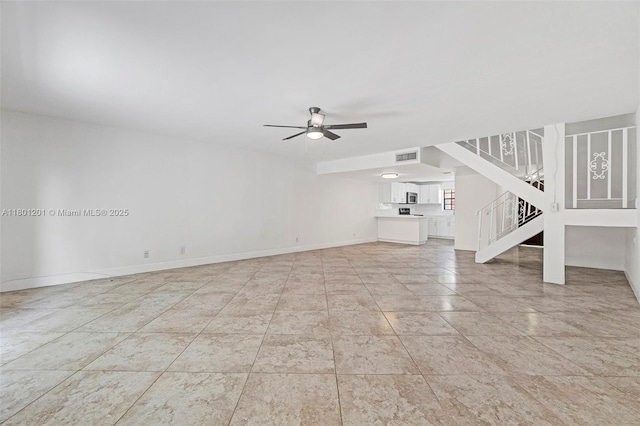unfurnished living room with stairs, a ceiling fan, and baseboards