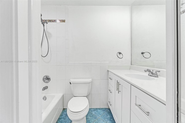 full bathroom featuring vanity, tile patterned flooring, toilet, bathing tub / shower combination, and tile walls