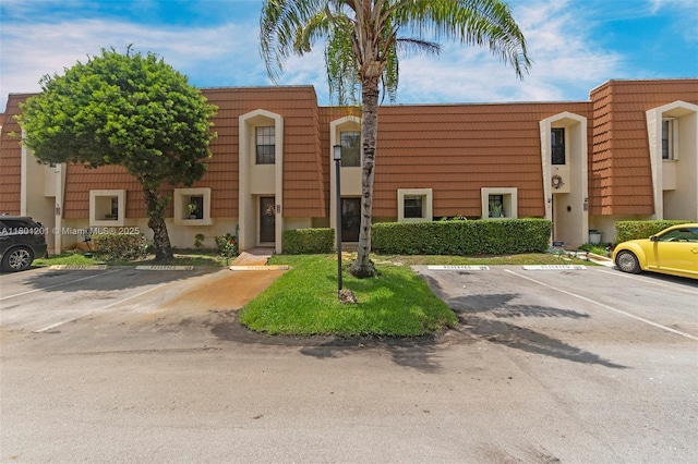 view of building exterior featuring uncovered parking
