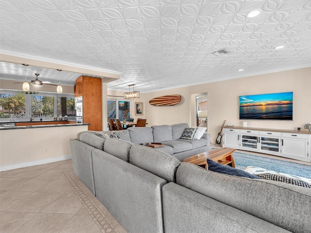 5119 Hayes St, Hollywood, FL 33021 - living area featuring an ornate ceiling, a chandelier, ornamental molding, light tile patterned flooring, and baseboards