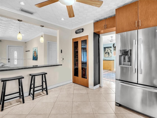 5119 Hayes St, Hollywood, FL 33021 - kitchen featuring stainless steel fridge with ice dispenser, ornamental molding, ceiling fan, brown cabinets, and light tile patterned floors