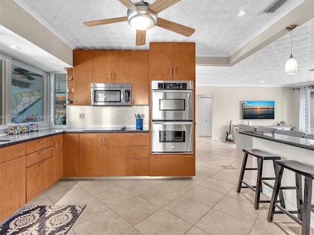 5119 Hayes St, Hollywood, FL 33021 - kitchen with stainless steel appliances, a ceiling fan, ornamental molding, pendant lighting, and light tile patterned floors