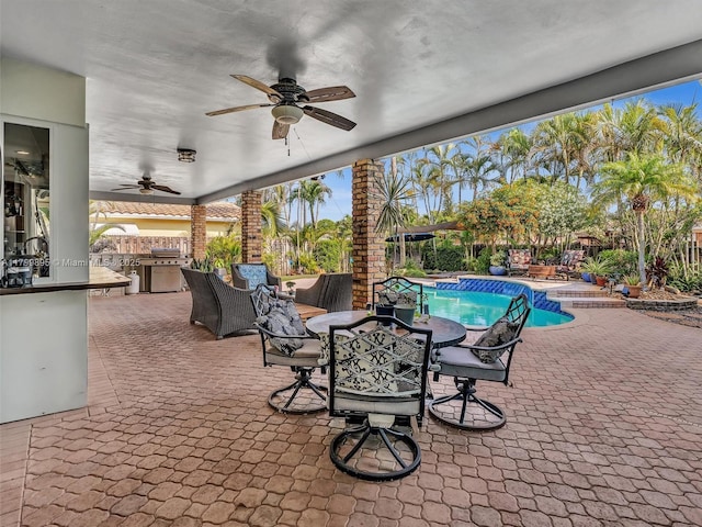 5119 Hayes St, Hollywood, FL 33021 - fenced backyard with an outdoor kitchen, a ceiling fan, a patio area, and outdoor dining space