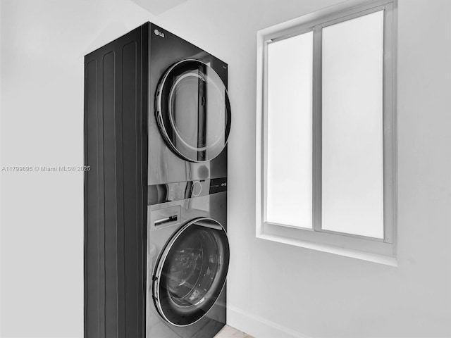 5119 Hayes St, Hollywood, FL 33021 - washroom with stacked washer and clothes dryer and baseboards