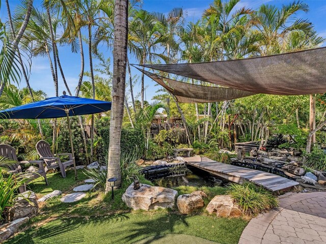 5119 Hayes St, Hollywood, FL 33021 - view of yard featuring a garden pond