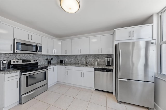 2751 S Ocean Dr Unit 403S, Hollywood, FL 33019 - kitchen featuring appliances with stainless steel finishes, a sink, light stone countertops, and tasteful backsplash