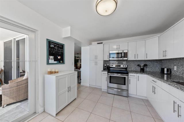 2751 S Ocean Dr Unit 403S, Hollywood, FL 33019 - kitchen featuring stainless steel appliances, tasteful backsplash, white cabinets, and light tile patterned floors