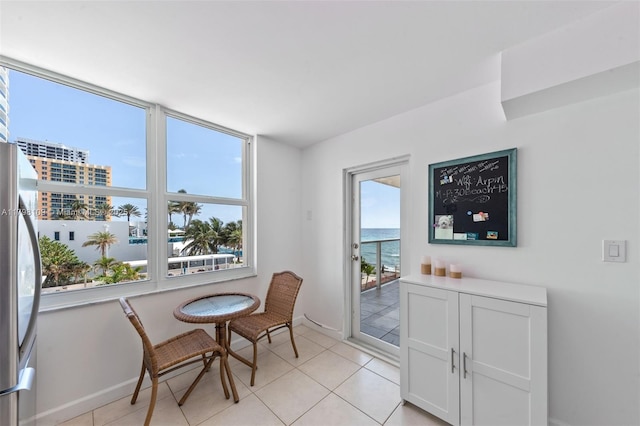 2751 S Ocean Dr Unit 403S, Hollywood, FL 33019 - dining room with light tile patterned floors, baseboards, and a water view