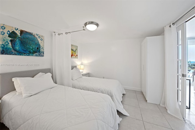2751 S Ocean Dr Unit 403S, Hollywood, FL 33019 - bedroom with light tile patterned floors and baseboards
