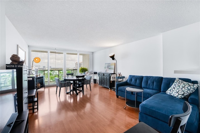 100 NW Bayview Dr Unit 1502, Sunny Isles Beach, FL 33160 - living room with wood finished floors, a textured ceiling, and floor to ceiling windows