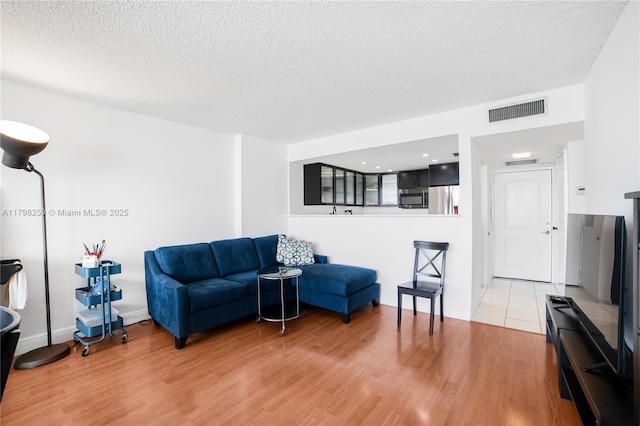 100 NW Bayview Dr Unit 1502, Sunny Isles Beach, FL 33160 - sitting room featuring light wood-style floors and a textured ceiling
