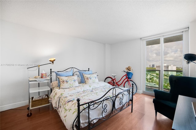 100 NW Bayview Dr Unit 1502, Sunny Isles Beach, FL 33160 - bedroom with wood finished floors, a textured ceiling, and floor to ceiling windows