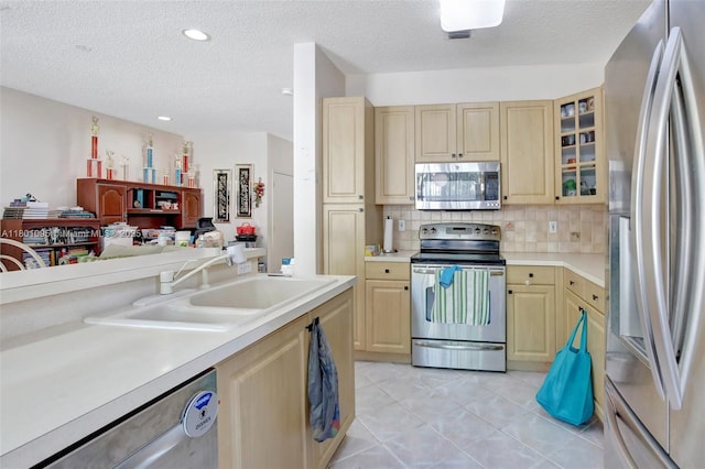 1562 NW 157th Ave, Pembroke Pines, FL 33028 - kitchen with appliances with stainless steel finishes, a sink, light brown cabinetry, light countertops, and a textured ceiling