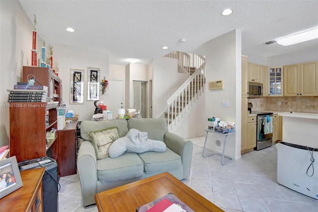 1562 NW 157th Ave, Pembroke Pines, FL 33028 - living area featuring light tile patterned floors, stairs, recessed lighting, and a textured ceiling