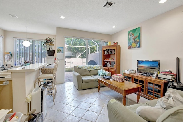1562 NW 157th Ave, Pembroke Pines, FL 33028 - living room featuring recessed lighting, light tile patterned flooring, and a textured ceiling