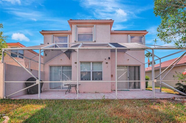 1562 NW 157th Ave, Pembroke Pines, FL 33028 - back of property with stucco siding, a patio, a yard, a tiled roof, and a lanai