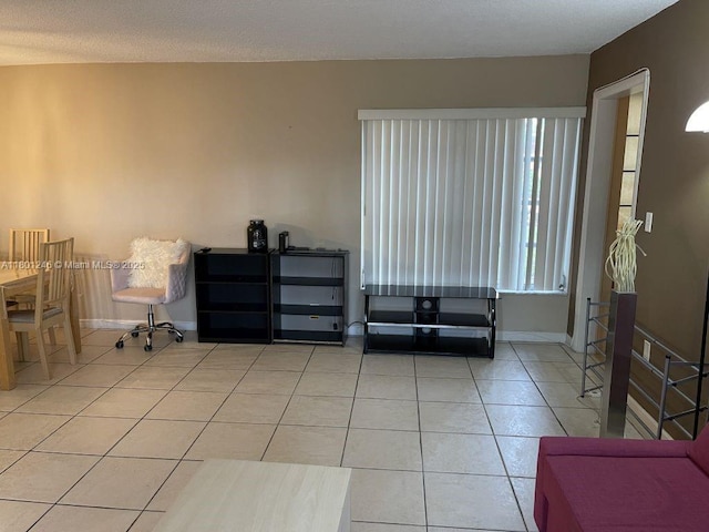 sitting room featuring light tile patterned floors and baseboards