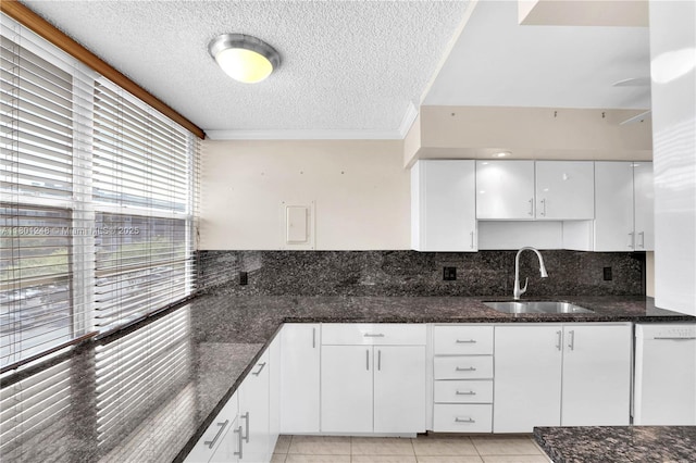 1000 Saint Charles Pl Unit 418, Pembroke Pines, FL 33026 - kitchen with a sink, a textured ceiling, dishwasher, white cabinets, and dark stone countertops