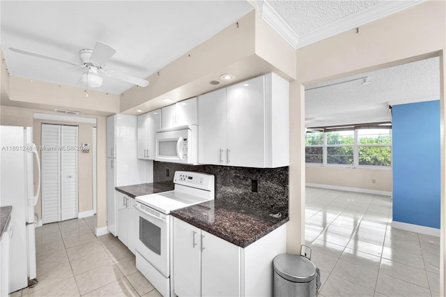 1000 Saint Charles Pl Unit 418, Pembroke Pines, FL 33026 - kitchen featuring white appliances, baseboards, a textured ceiling, light tile patterned floors, and white cabinets