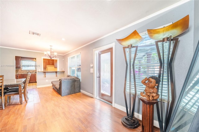 18000 NW 6th Pl, Miami Gardens, FL 33169 - living area with a chandelier, crown molding, light wood-style floors, and baseboards