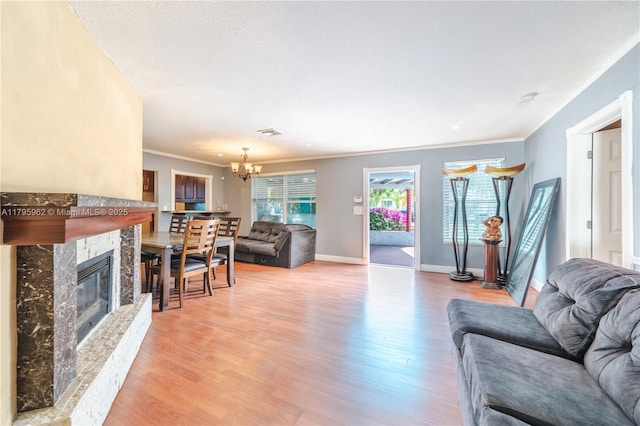 18000 NW 6th Pl, Miami Gardens, FL 33169 - living area with wood finished floors, a chandelier, crown molding, baseboards, and a high end fireplace