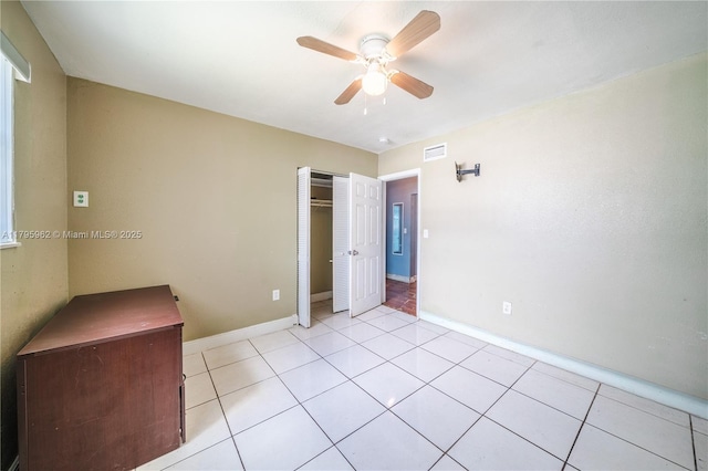 18000 NW 6th Pl, Miami Gardens, FL 33169 - unfurnished bedroom featuring a closet, baseboards, light tile patterned floors, and a ceiling fan