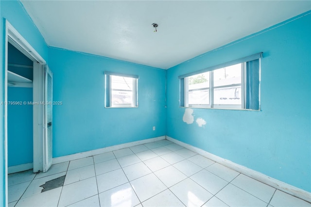18000 NW 6th Pl, Miami Gardens, FL 33169 - empty room featuring plenty of natural light, baseboards, and light tile patterned flooring