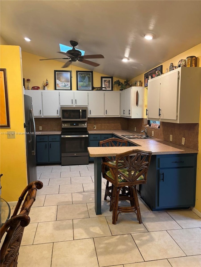 kitchen featuring black electric range oven, stainless steel microwave, fridge with ice dispenser, lofted ceiling, and tasteful backsplash