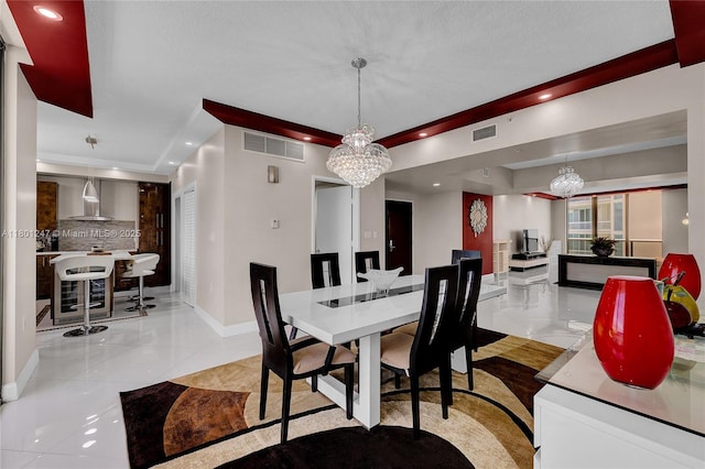 16275 Collins Ave Unit 2002, Sunny Isles Beach, FL 33160 - dining area with baseboards, a chandelier, recessed lighting, a tray ceiling, and light tile patterned flooring