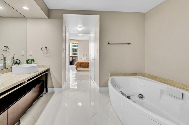 16275 Collins Ave Unit 2002, Sunny Isles Beach, FL 33160 - ensuite bathroom with baseboards, a whirlpool tub, vanity, and tile patterned flooring