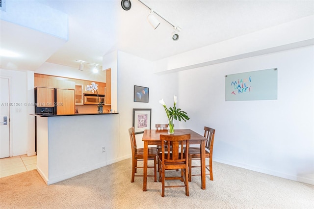 335 S Biscayne Bl Unit 902, Miami, FL 33131 - dining area with rail lighting, light carpet, and baseboards