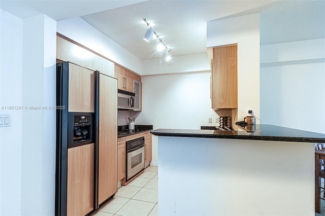 335 S Biscayne Bl Unit 902, Miami, FL 33131 - kitchen with stainless steel appliances, light tile patterned floors, a peninsula, light brown cabinetry, and rail lighting