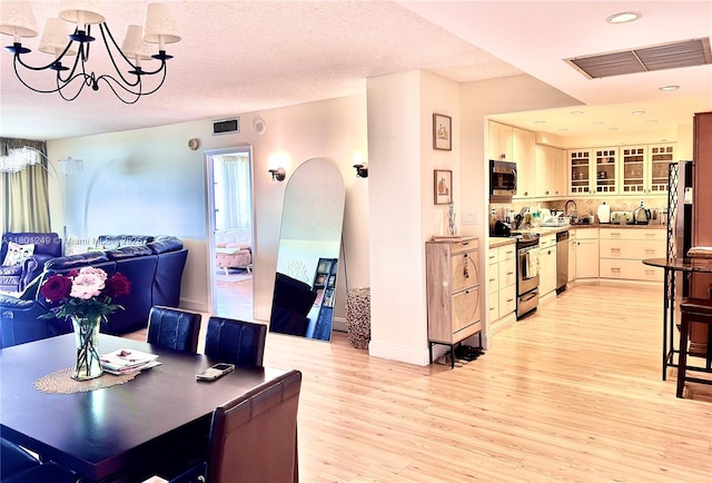 600 Three Islands Blvd Unit 905, Hallandale Beach, FL 33009 - dining room featuring light wood-type flooring, a chandelier, arched walkways, and recessed lighting