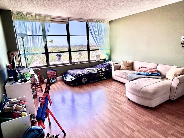 600 Three Islands Blvd Unit 905, Hallandale Beach, FL 33009 - living room featuring wood finished floors, plenty of natural light, and a textured ceiling