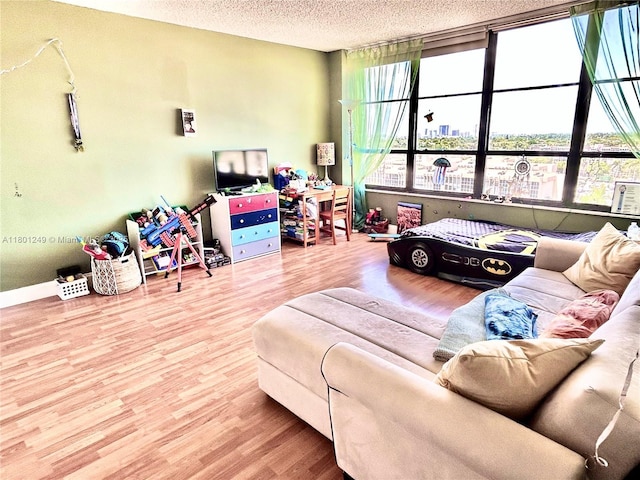 600 Three Islands Blvd Unit 905, Hallandale Beach, FL 33009 - living room featuring wood finished floors, a textured ceiling, and baseboards