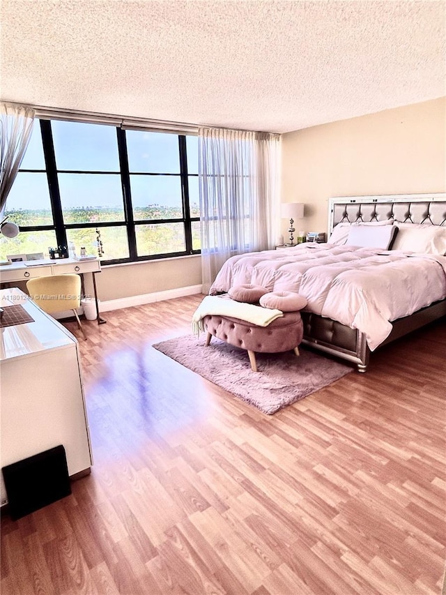 600 Three Islands Blvd Unit 905, Hallandale Beach, FL 33009 - bedroom with wood finished floors, a textured ceiling, and baseboards