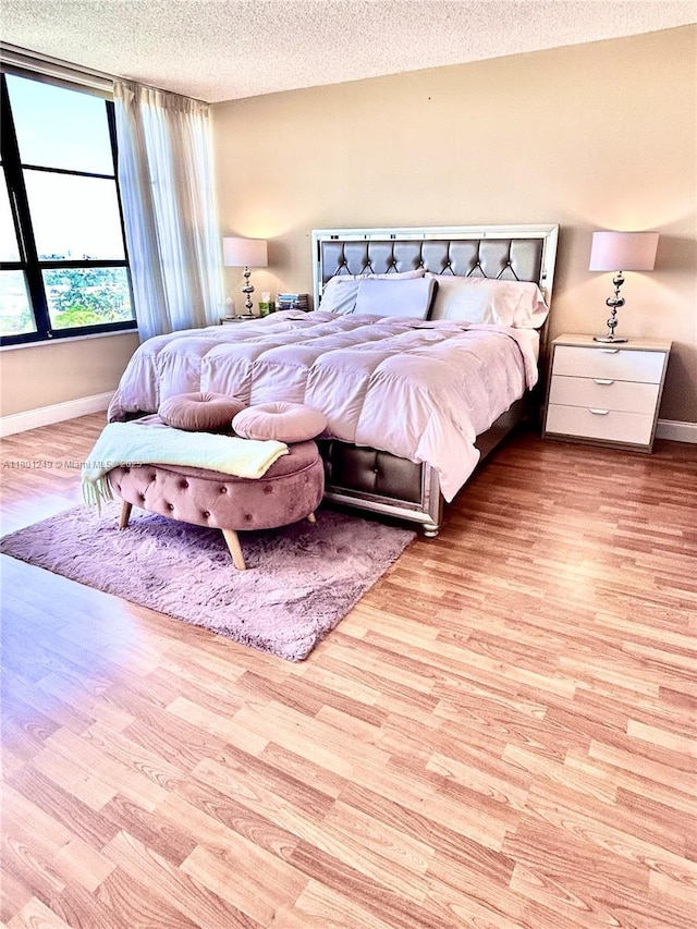 600 Three Islands Blvd Unit 905, Hallandale Beach, FL 33009 - bedroom with a textured ceiling, wood finished floors, and baseboards