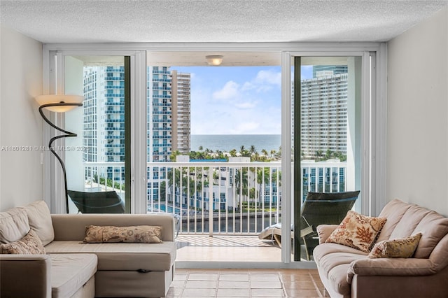 121 Golden Isles Dr Unit 905, Hallandale Beach, FL 33009 - doorway with a water view, healthy amount of natural light, floor to ceiling windows, tile patterned floors, and a textured ceiling