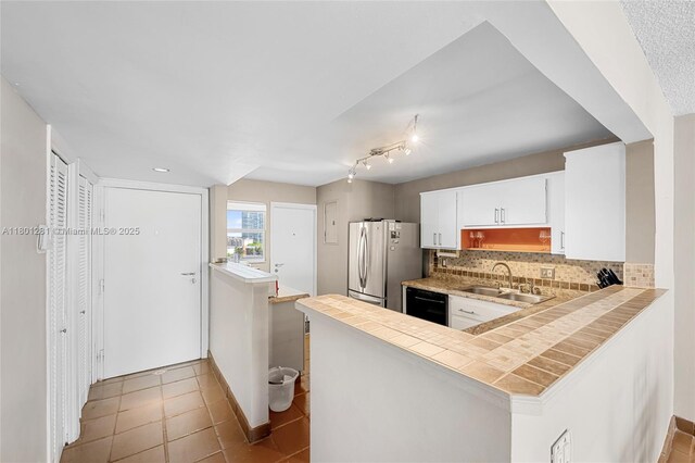 121 Golden Isles Dr Unit 905, Hallandale Beach, FL 33009 - kitchen featuring a sink, freestanding refrigerator, dishwasher, backsplash, and white cabinets