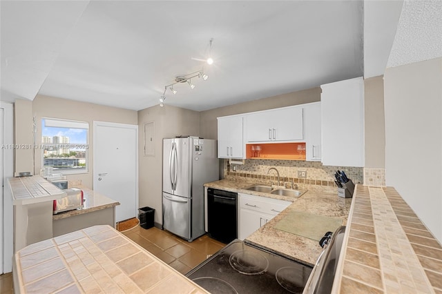121 Golden Isles Dr Unit 905, Hallandale Beach, FL 33009 - kitchen with a sink, black appliances, backsplash, white cabinetry, and light countertops